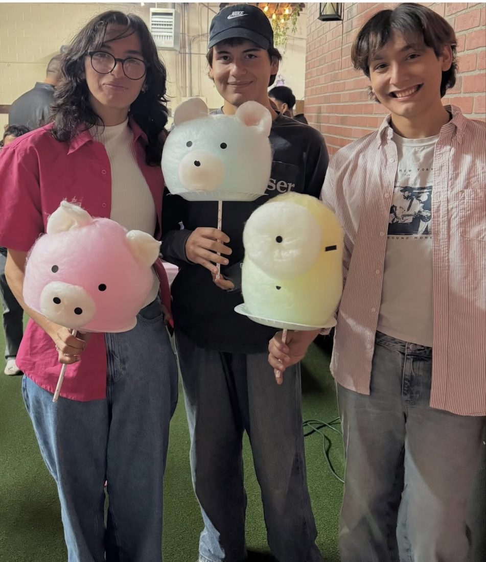 Friends sharing cotton candy clouds at a celebration